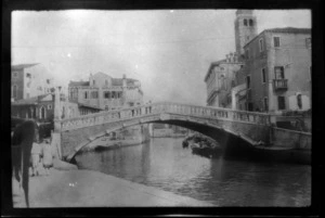 Stone bridge over canal between buildings, Venice, Italy