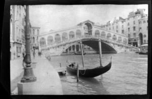 Gondolier in a gondola moored by the Bridge of Sighs, Venice, Italy