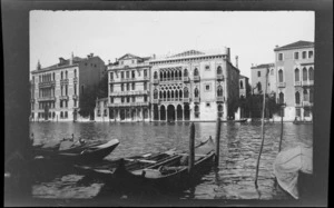 Gondolas moored in wide canal, including several palazzo style buildings opposite, Venice, Italy