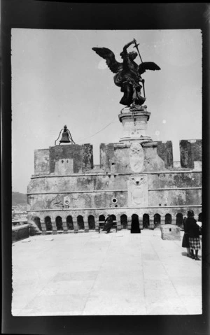 Statue of winged angel with sword on top of unidentified building, Rome, Italy