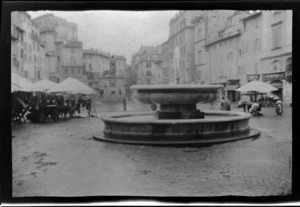 View of Campo de Fiori fountain, market stalls, buildings and Giordano Bruno statue, Rome, Italy
