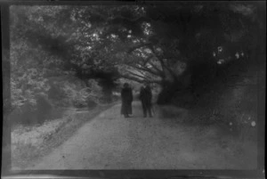 William and Lydia Williams standing on road next to river, trees and shrubs, Killarney, County Kerry, Ireland