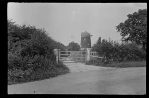 Bicycle leaning against gate of farm with windmill, [Winslow, Buckinghamshire, England?]