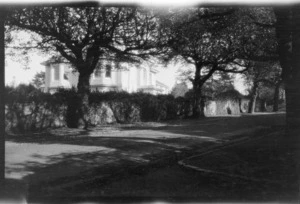 Large two-storied house behind hedge, [Devon?], England