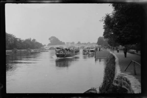 Passenger boat ['Viscountess'?], passing other boats on River Thames, and people walking on path beside river, with bridge in the background, between London and Oxford, England