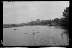 Unidentified scullers on the River Thames, including passenger boats moored and Windsor Castle in the background, Windsor, Berkshire, England