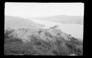 Rocky hilltop above inlet [Port Hills, Canterbury region, with view of Lyttelton Harbour?]