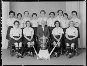 Wellington women's hockey representatives team with trophy