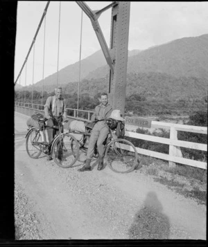 Edgar Williams and an unidentified man, with bicycles, on suspension bridge over Fox River, West Coast Region