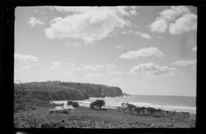 Landscape view of farmhouse and paddock, including beach and bluff, unknown location
