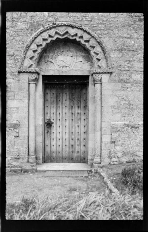 Church doorway with iron cast door handle and engraved arch above, Buckinghamshire, England