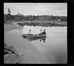 Three unidentified people in a punt, on [Owaka?] river at Pounawea, Catlins District, South Otago Region