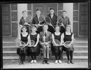 Tennis team with tennis racquets and trophy cup at Westport Technical High School, West Coast Region, outside brick building