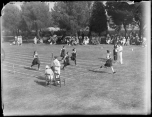 Running race at Westport Technical High School, West Coast Region, showing female students crossing finish line in front of a crowd of spectators