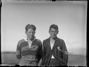 Two unidentified schoolboys, one wearing a rugby jersey and the other a striped blazer, both wearing prize-ribbons, from Westport Technical High School, West Coast Region