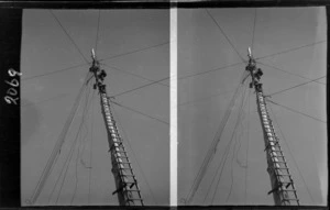 Three unidentified linesmen climbing a power pole, location unidentified