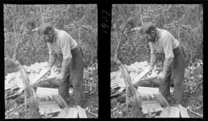 An unidentified man, who is smoking a pipe, making wooden shingles with a froe, in the bush, [West Coast Region?]