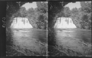 Staircase waterfall flowing into river in bush, [Waikato Region?]