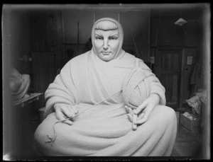 Sculpture of a woman wearing a robe holding a ball of yarn, by Francis Shurrock