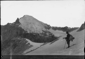 A mountain climber [Edgar Williams?] standing on a mountain slope, [Fiordland National Park?]