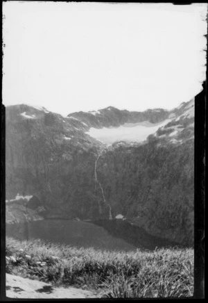 Waterfall on mountainside, with lake below and above, [Fiordland National Park?]
