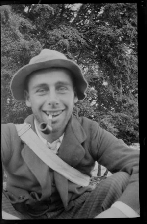 Portrait of an unidentified young man smoking a pipe, [beech?] trees beyond, [Canterbury, Otago or Southland?]