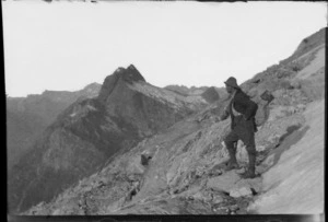 [Jack Murrell] wearing a pack with billy on top, on a rocky mountain slope, [West Coast Region]