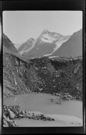 Pool, moraine, and mountains [and Lyell Glacier?] beyond, Southern Alps, Canterbury Region