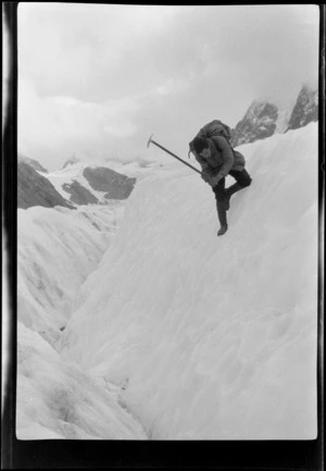 Edgar Williams wielding an icepick on a steep part of Lyell Glacier, Southern Alps, Canterbury Region