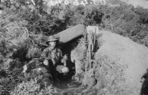 Soldier holding a Turkish shell at entrance to dug-out, Gallipoli, Turkey