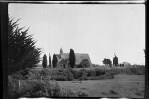 View across farmland to Anglican church and cemetery, Woodend, Canterbury Region