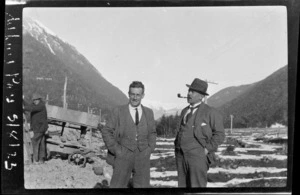 Two unidentified men, one smoking a pipe, at Arthur's Pass Railway Station, Selwyn District, Canterbury Region