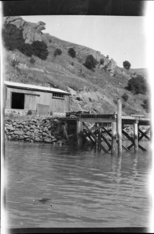 Jetty at the base of a hill, location unidentified