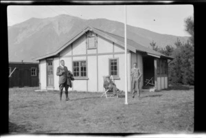 Three unidentified men [Messrs Waldrop, Fisher and Willis?] outside a wooden cottage, at New Zealand Public Works Department camp, at the Harper Diversion, Selwyn District, Canterbury Region