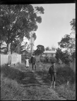 Elderly man and children in St Saviour's Church yard, Kaitaia
