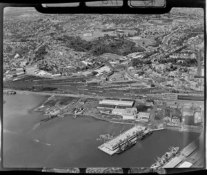 View of Ports of Auckland wharf area, Tamaki Drive and Auckland Railway Station to the Museum and Auckland Domain beyond, Auckland City
