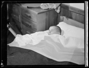 A boy at Polish refugee camp, asleep in bed, Pahiatua