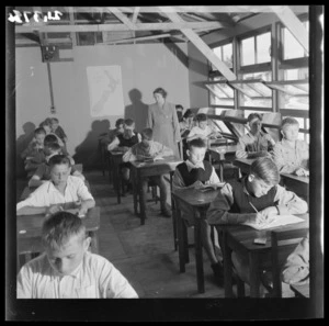 Mrs Krystyna Skwarko watches her pupils study in the boys' classroom at a Polish refugee camp, Pahiatua