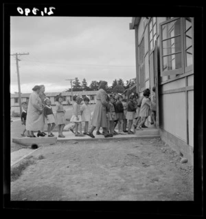 Pani Petrus and a group of young girls enter a dining room at a Polish refugee camp, Pahiatua