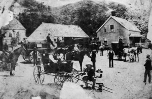 Scene in Parliament Street, Lower Hutt, with coaching stables, carriages and horses