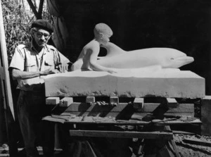 Weigel, William George, 1890-1980 : Russell Clark putting the finishing touches to the statue of Opononi's dolphin Opo