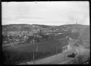 View of The Glen, South Dunedin, with a train crossing the railway overpass above South Road.