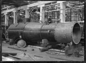 Locomotive boiler in the Petone Railway Workshops, with William Albert Godber sitting on top