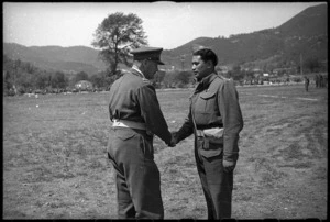 Major J Matehaere, New Zealand World War 2 soldier, receiving the Military Cross from General Freyberg, Italy