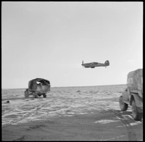 Low flying fighter support plane patroling New Zealand columns in Egypt during World War 2 - Photograph taken by H Paton