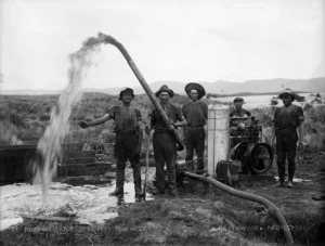 Gum diggers pumping water out of gum hole