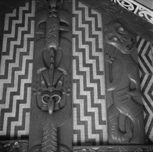 Maori wooden carvings and tukutuku panels inside Tu Kaki meeting house at Te Kaha