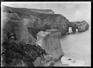 Cliffs and rock arches forming a natural bridge at Tunnel Beach, ca 2 km west of St Clair, Dunedin.
