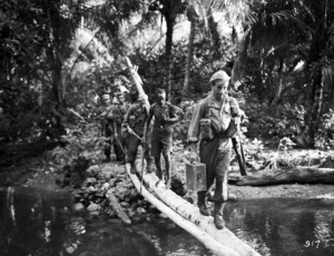 Soldiers crossing a river in the Pacific Region during World War II