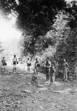Japanese men, women, and children, in a country road